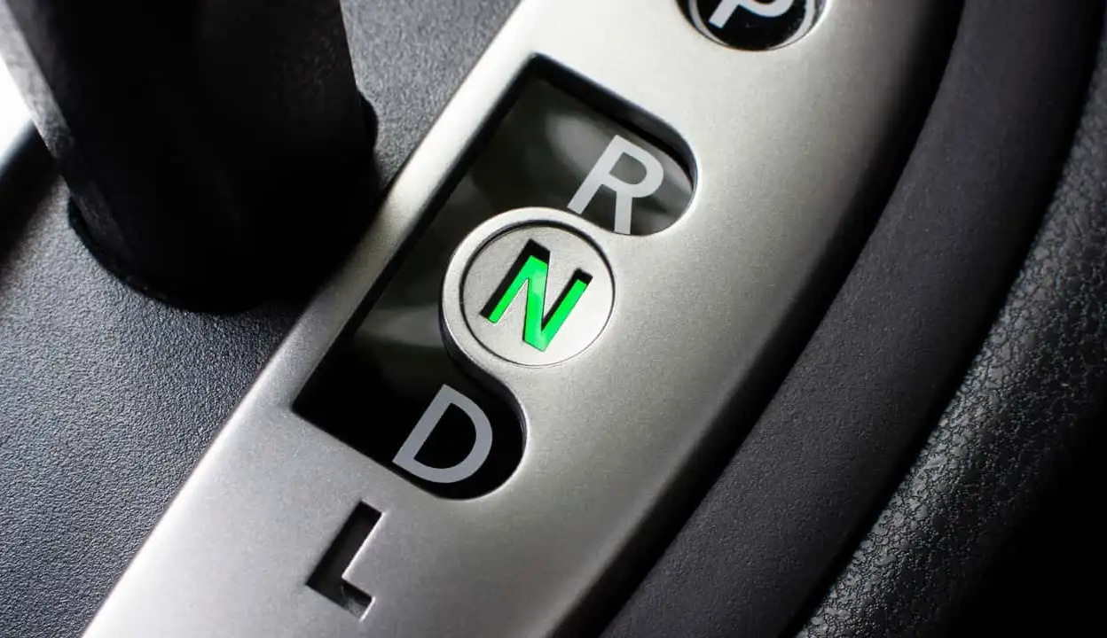 Can shifting an automatic transmission into neutral while driving damage the car?
